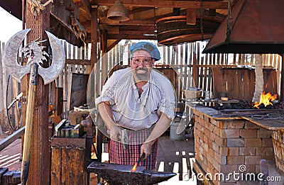 Blacksmith Forging Metal with Hammer Editorial Stock Photo