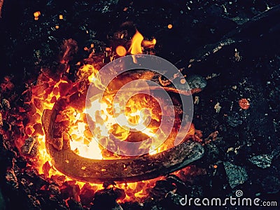 Blacksmith form horse shoe from semiproduct Stock Photo