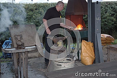 Blacksmith heating metal Editorial Stock Photo