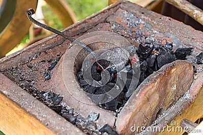 Blacksmith horn with burning coals for the manufacture and smelting of metal, forge closeup traditional craftsman Stock Photo