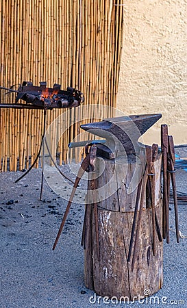 Blacksmith manually forging on the street, in the open Stock Photo