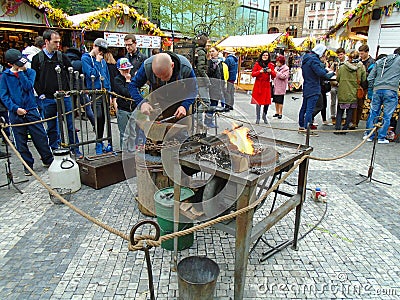 Blacksmith and an old blacksmith work at the Easter markets. Prague, Czech Republic, Editorial Stock Photo