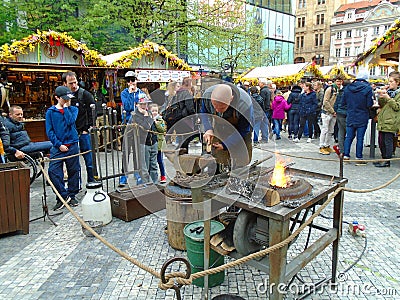 Blacksmith and an old blacksmith work at the Easter markets. Prague, Czech Republic, Editorial Stock Photo