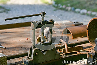 Blacksmith`s clamp. Metal clamping device on an old workbench. Vise desktop Stock Photo