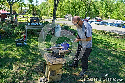 Blacksmith at Work at the Explore Park Editorial Stock Photo