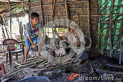 Blacksmith working in his smithy Editorial Stock Photo