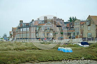 Blakeney flint cottages and marsh. Editorial Stock Photo