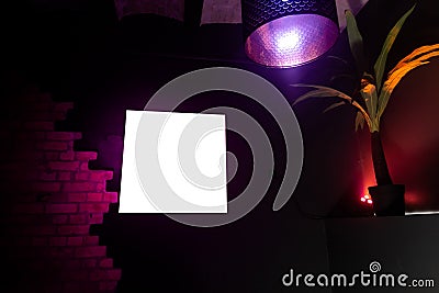 Blank ad frame space in a nightclub with a palm tree Stock Photo