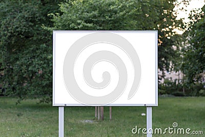 Blank ad space sign infront of trees Stock Photo