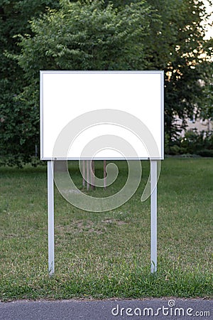 Blank ad space sign infront of trees Stock Photo