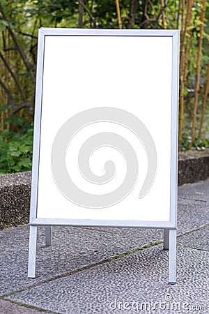 Blank ad space sign infront of trees in a park Stock Photo