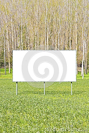 Blank advertising signboard in a countryside with forest in the background - concept with space for inserting text Stock Photo