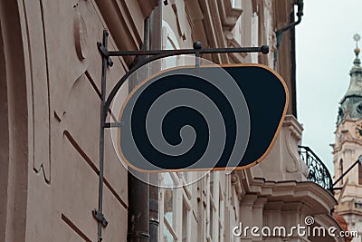 Blank Antique Black Store Signboard Mock up. Empty Shop Signage Template on Ancient Wall in European Town. Street sign Stock Photo