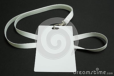 Blank badge mockup isolated on black. Plain empty name tag mock up hanging on neck with string Stock Photo