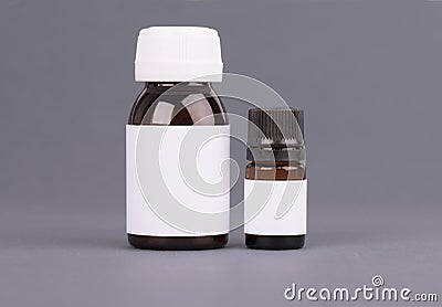 Blank big and medium size medicine white plastic packaging bottles for cosmetics, vitamins, pills or capsules. Packaging Stock Photo