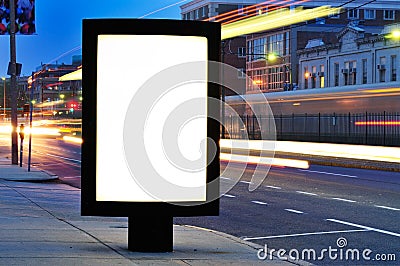 Blank Billboard on City Street at Night Stock Photo