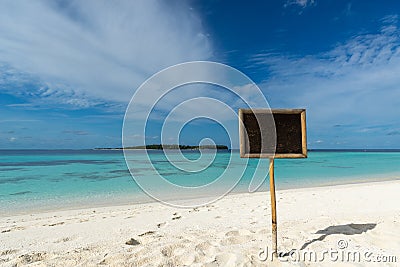 Blank black board on tropical beach background. Stock Photo