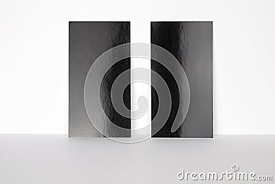 2 blank black business cards locked on white wall, 3.5 x 2 inches size as template for design presentation, showcase etc Stock Photo
