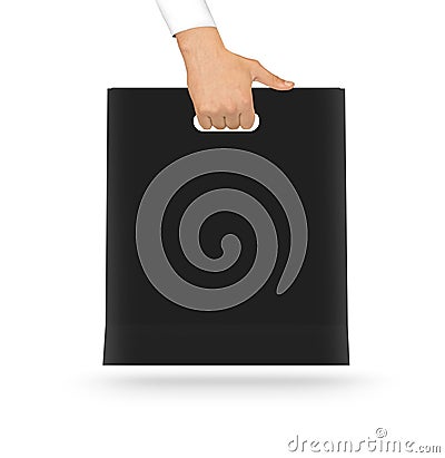 Blank black paper bag mock up holding in hand. Empty plastic pac Stock Photo