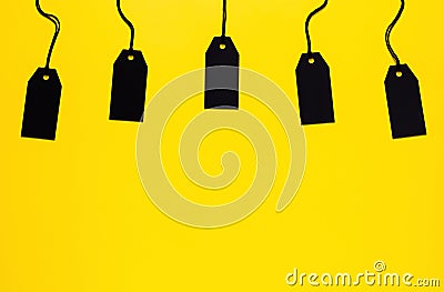 Blank black price tags on yellow background Stock Photo