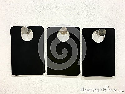 Blank Black Tags On White Wall Stock Photo