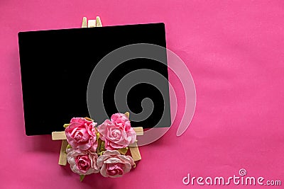 blank blackboard and pink flower on pink background with copy space, Valentines Day concept Stock Photo