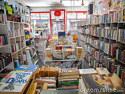 Blank Books on a quiet afternoon. Colorful assortment of books stacked on shelves. Editorial Stock Photo