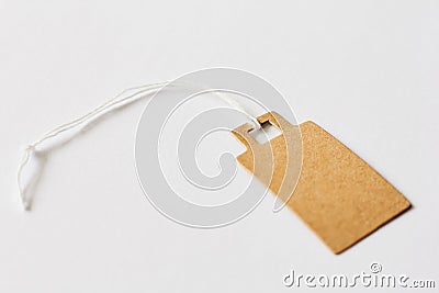 Blank brown cardboard price tag, sale tag, gift tag, address label on white background Stock Photo