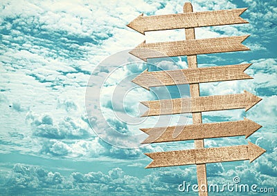 Blank brown wooden signpost against blue sky. Stock Photo