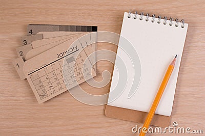 Blank business agenda on business table. Calendar and pencil on wooden table. Stock Photo