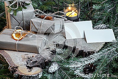 Blank business cards on christmas tree branches, new year decor and gift boxes. Stock Photo