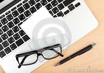 Blank business cards over laptop on office table Stock Photo