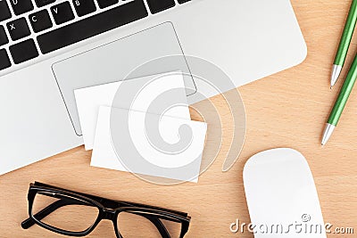 Blank business cards over laptop on office table Stock Photo