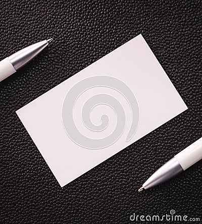 Blank card on dark texture background. White contact card for your design Stock Photo