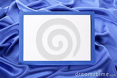 Blank Christmas or birthday greetings card or invitation with blue satin background, copy space Stock Photo