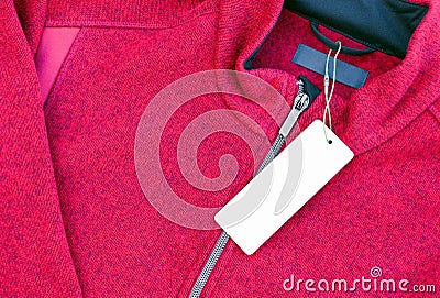 Blank clothing label tag on a red jacket Stock Photo