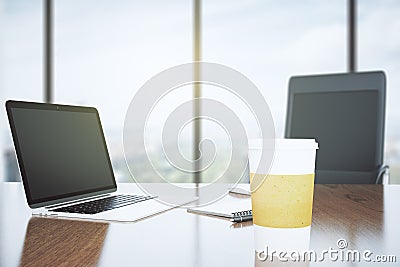 Blank coffee cup on a wooden desk and laptop Stock Photo