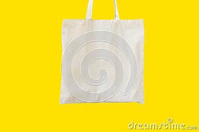 Blank cotton white shopper tote bag on yellow background. Mock up template Stock Photo