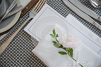 Blank Course menu paper on Party table decorated with beautiful flowers Stock Photo