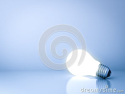 Blank creative idea background concept with one glowing idea light bulb on blue Stock Photo