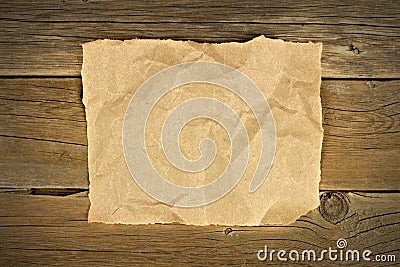 Blank crumbled brown paper on rustic wood Stock Photo