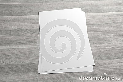 Blank 3D illustration stack of flyer or leaflet on wooden background Cartoon Illustration
