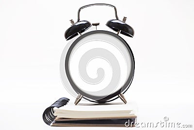 The blank alarm clock is on the diary Stock Photo