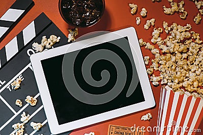 Blank digital tablet, popcorn, filmstrip, cinema and movie onlin Stock Photo