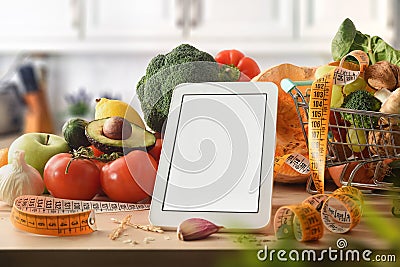 Blank electronic device on kitchen for preparing healthy dishes front Stock Photo