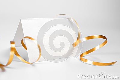 Blank folded thank you or greeting card with gold ribbon Stock Photo