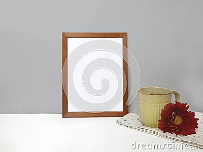 Blank frame mockup on table over stone wall Stock Photo