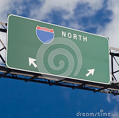 Blank freeway sign in blue cloudy sky Stock Photo