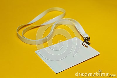 Blank identification card with white neckband isolated on yellow background Stock Photo