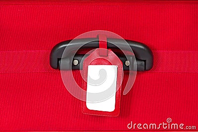 Blank identification tag over red suitcase Stock Photo